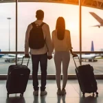 traveling-couple-with-luggage-standing-together-airport-waiting-departure-back-view_899263-16462 (convert.io)